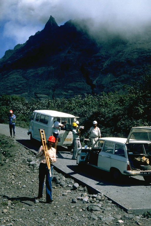 Scientists unload equipment in October 1976 to measure deformation of the volcanic edifice at Savane à Mulets, on the south side of the summit lava dome.  This was one of several tools used to monitor the volcano during the 1976-77 eruption.  Photo by Richard Fiske, 1976 (Smithsonian Institution).