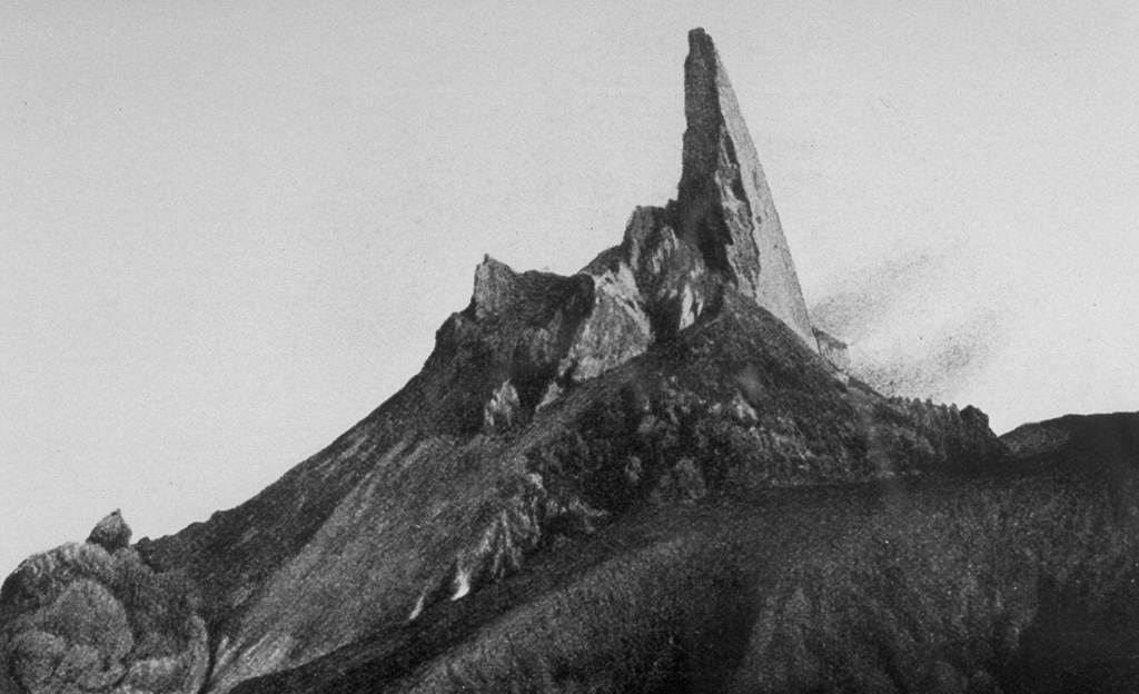 One of the most dramatic events following the devastating 1902 eruptions of Mount Pelee in Martinique was the growth of a towering spine on the summit lava dome.  It began to rise above the dome on November 3, 1902.  By May 31, 1903, the spine reached a height of 350 m above the dome, temporarily creating a 1617-m-high peak at the summit.  It then slowly disintegrated and was gone by the end of the eruption.  This March 11, 1903, photo shows the spine near its peak height, with a smoothly extruded eastern side. Photo by A. Lacroix, 1903 (from the collection of Maurice and Katia Krafft).