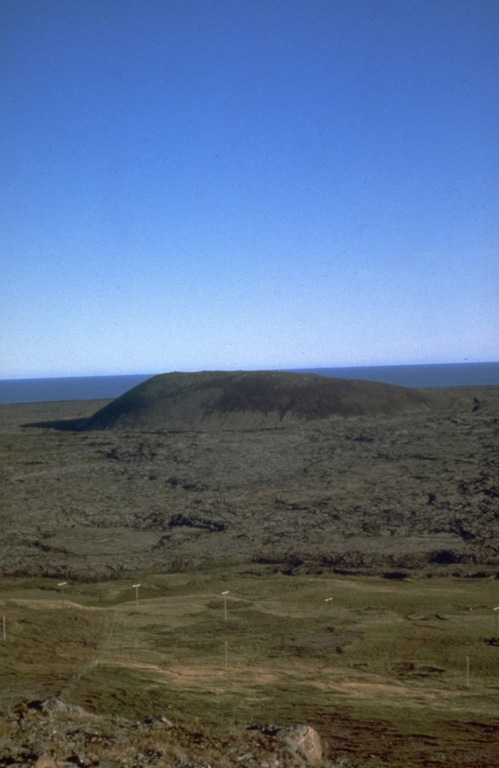 The Búðaklettur scoria cone on the east flank of Snæfellsjökull in western Iceland was the source of the Búðahraun lava flow covering 18 km2 and forming a peninsula. Holocene lava flows form much of the surrounding coastline. Photo by Richie Williams, 1981 (U.S. Geological Survey).