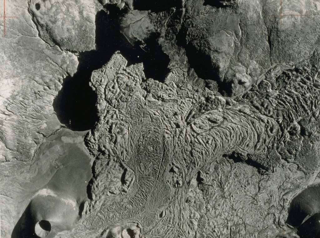 This vertical aerial photo (with south to the top) shows the Gráakúla scoria cone at the lower left, which erupted about 4,000 years ago and produced this lava flow that entered Selvallavatn lake. The flow is part of the Ljósufjöll volcanic system, which contains of a group of scoria cones and lava flows along a roughly 90-km-long WNW-ESE trend.  Photo by Landmælingar Islands, courtesy of Jack Green (published in Green and Short, 1971).