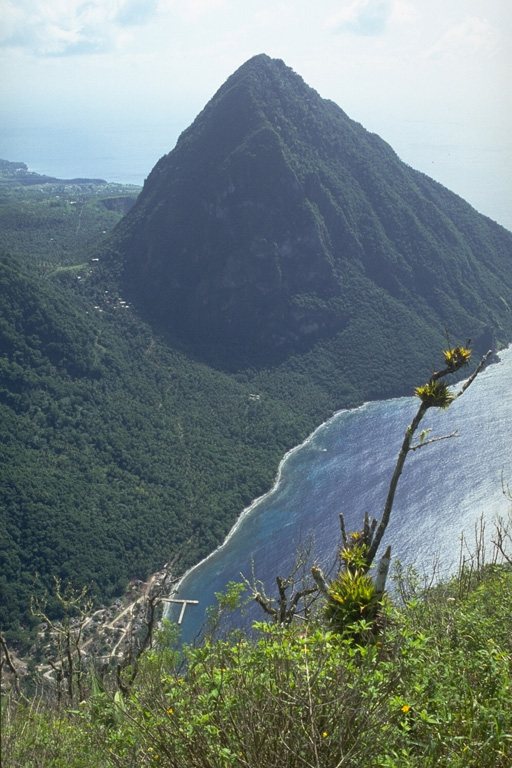 Gros Piton, seen here from the summit of the Petit Piton, is the southernmost of the twin lava domes that are the hallmark of the island of St. Lucia.  The 777-m high and 3-km wide dacitic dome was erupted about 260,000 years ago.  Rocks of a small tuff ring are exposed at its base. Photo by Lee Siebert, 1991 (Smithsonian Institution).