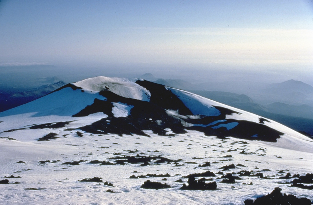 Axlargigur, at the SW end of Hekla's summit ridge, was one of the principal vents during a major eruption in 1947.  The initial plinian phase of the eruption began on March 29, 1947, and produced a towering ash column that reached a height of 30 km.  Tephra fall occurred primarily to the south, and ashfall reached the Finnish-Russian border.  Lava flows from a 5-km-long fissure along the summit ridge covered 40 sq km, primarily on the eastern, southern, and western sides of the volcano.  Copyrighted photo by Katia and Maurice Krafft.