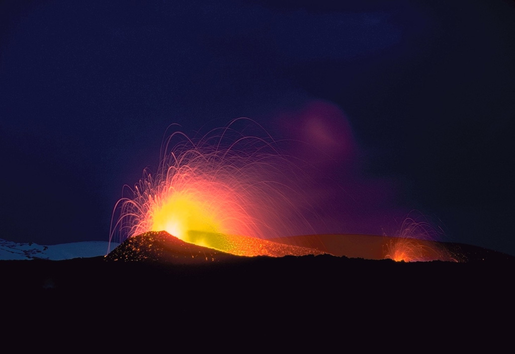 Strombolian eruptions from two vents on a fissure on the northern flank of Hekla volcano in May 1970. Three areas were active in 1970, producing lava flows to the N, W and SW. The Oldugigar vent (erupting in the foreground) and the nearby Hlidagigar vent were the source of the most voluminous lava flows of the 1970 eruption. The lava flows traveled 6 km N over uninhabited land. Photo by Robert Citron, 1970 (Smithsonian Institution; courtesy of William Melson)