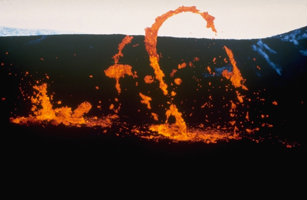 Ribbons of molten lava are thrown from a vent at Krafla volcano in October 1980 during a period of low-intensity activity. Four eruptive episodes occurred at Krafla during 1980. One of these, a brief episode of phreatic activity on 15 June, was explosive. The other three eruptive phases, in March, July, and October, were dominantly effusive. Photo courtesy of Gudmundar Sigvaldason, 1980 (Nordic Volcanological Institute, Reykjavik).