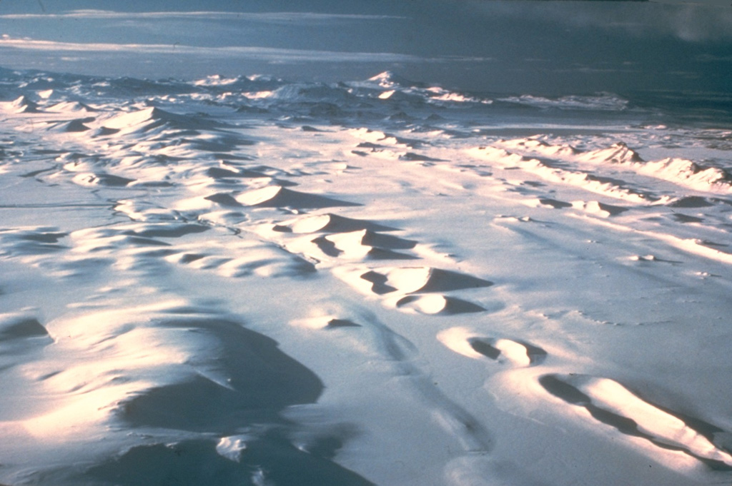 The Veidivötn fissure system, which extends about 100 km SW from Bárdarbunga volcano, has been the source of major eruptions during the Holocene. The approximately 60-km-long Vatnaöldur crater row, seen stretching across this image, formed during a major eruption on the southern part of the fissure system in about 877 CE. The explosive eruption produced large volumes of tephra and small lava flows. The peak on the center horizon is Hekla volcano. Photo by Ingibjörg Kaldal (Icelandic National Energy Authority).