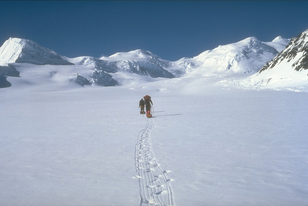 A U.S. Geological Survey climbing party ascends the Klutlan Glacier headed towards Mount Churchill. Their field studies led to the discovery that this volcano was the site of two of the most voluminous eruptions in North America in the past 2,000 years. The White River Ash originated from the summit caldera of Churchill next to Mount Bona and comprises two voluminous ash units that extend across most of Canada and traces reached Europe. Photo by Game McGimsey (U.S. Geological Survey, Alaska Volcano Observatory).