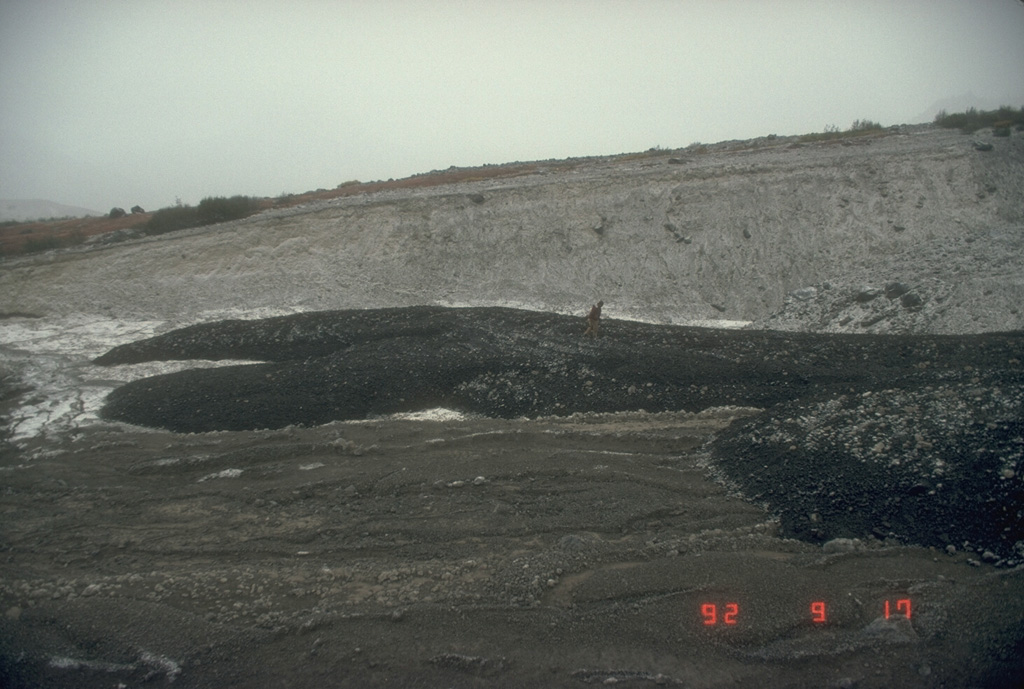 An Alaska Volcano Observatory scientist examines lahar deposits originating from the 1992 eruption of the Crater Peak vent at Mount Spurr. These deposits were emplaced the night of 16-17 September during the last of three short, but powerful, explosive eruptions from June to September. Photo by Game McGimsey (Alaska Volcano Observatory, U.S. Geological Survey).