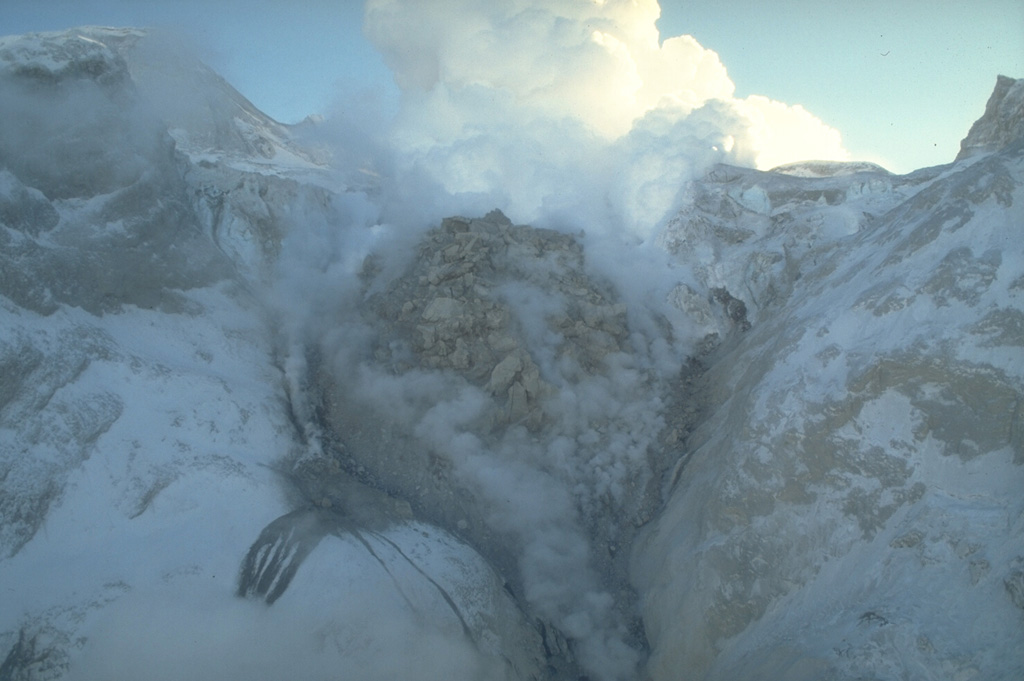 The 1989-90 eruption of Redoubt was characterized by repeated growth and destruction of lava domes from a vent on steep slopes in the summit crater. This view from the north on 2 February 1990 shows the second largest lava dome, which was destroyed during an explosive eruption on 15 February. Photo by Game McGimsey, 1990 (Alaska Volcano Observatory, U.S. Geological Survey).