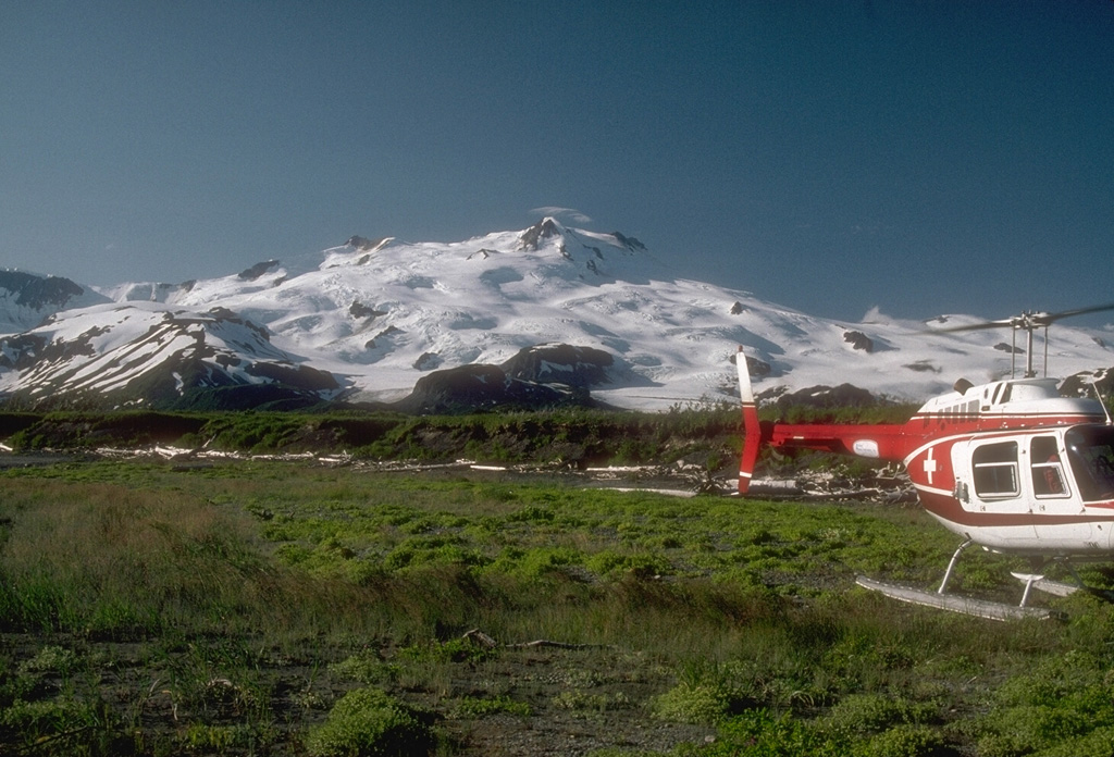 Mount Douglas is largely ice-covered and located at the northern tip of the Alaska Peninsula, is seen here from the north. The summit crater contains a warm, acidic lake. Photo by Chris Nye (Alaska Division of Geological and Geophysical Surveys, Alaska Volcano Observatory).