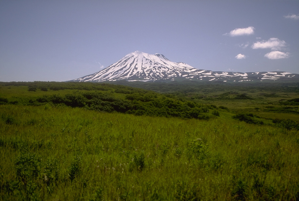 Mount Peulik was constructed immediately north of Ugashik caldera. It is seen here from NW near Ukinrek Maars. The hummocky terrain in the foreground is a debris avalanche deposit produced by the collapse of ancestral Peulik.  Photo by Christina Neal, 1993 (Alaska Volcano Observatory, U.S. Geological Survey).
