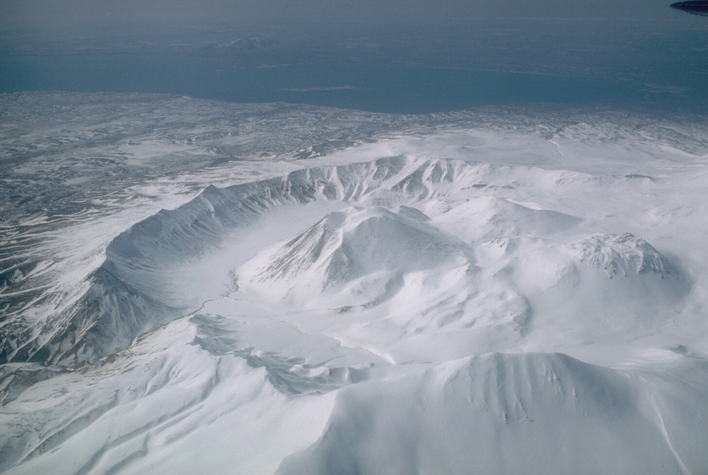 The 4.5-km-wide Ugashik caldera formed during the late Pleistocene. Five Holocene lava domes are in the caldera, seen here from the east with Upper Ugashik Lake in the background. Photo by Betsy Yount (Alaska Volcano Observatory, U.S. Geological Survey).