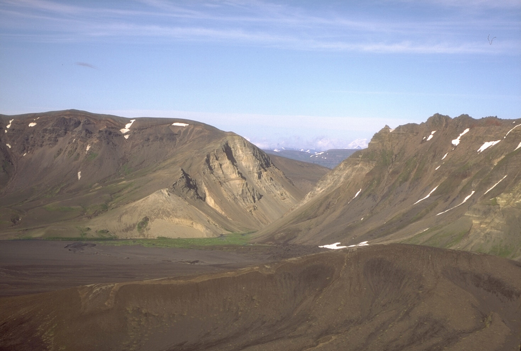 The Gates is a v-shaped notch in the 1-km-high eastern rim of Aniakchak caldera. Surprise Lake was once much larger but is now restricted to the NW part of the caldera floor. It is thought to have drained catastrophically through The Gates at the time of an eruption at Half Cone about 500 years ago. Photo by Christina Neal, 1994 (Alaska Volcano Observatory, U.S. Geological Survey).
