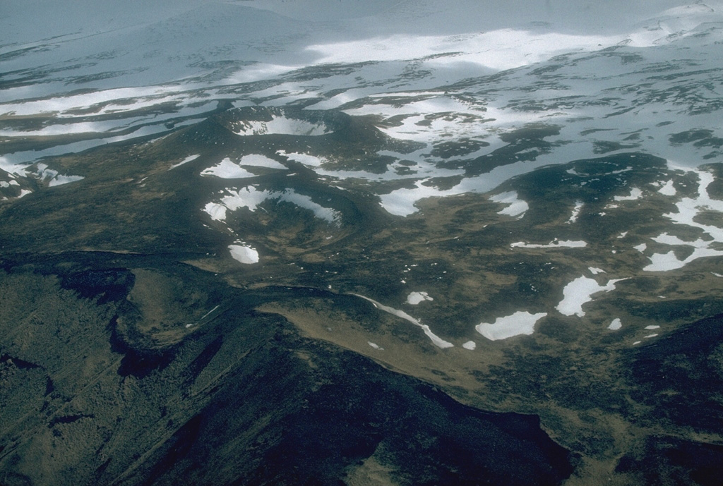 The Point Kadin vents low on the NW flank of Makushin are a dozen or so craters and small scoria cones. They erupted along a WNW-trending fracture zone that extends to the coast. Photo by Chris Nye, 1994 (Alaska Division of Geological & Geophysical Surveys, Alaska Volcano Observatory).