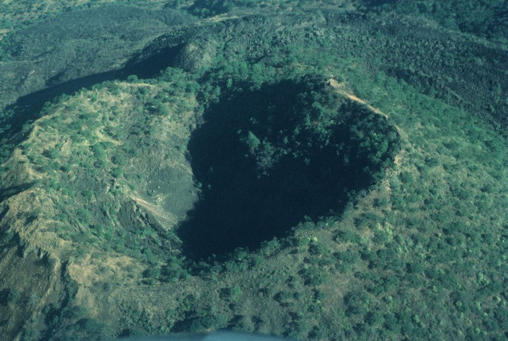 Since the end of the 1759-1774 eruption the Jorullo crater has been collapsing inward along steep, arcuate faults, increasing its dimensions to 400 x 500 m; its depth was 150 m by 1997.  Photo by Jim Luhr, 1997 (Smithsonian Institution).