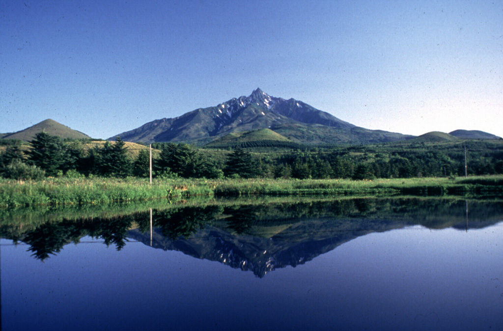 Rishiri is a highly eroded edifice forming an island off the NW tip of Hokkaido. The main edifice contains scoria cones on the flanks, with a maar containing this lake on the lower S flank. It was constructed during the Pleistocene and scoria cones and the maars on the lower flanks erupted 30,000-8,000 years ago. Photo by Yoshihiro Ishizuka, 1993 (Hokkaido University).