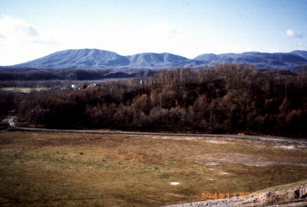 Kuttara volcano, seen here from Shiraoi town, is a low cone that has a 3-km-wide caldera at its summit. The caldera formed during the late Pleistocene, but minor explosions occurred from a crater in a western-flank thermal area as recently as about 200 years ago. Photo by Mihoko Moriizumi, 1995 (Hokkaido University).