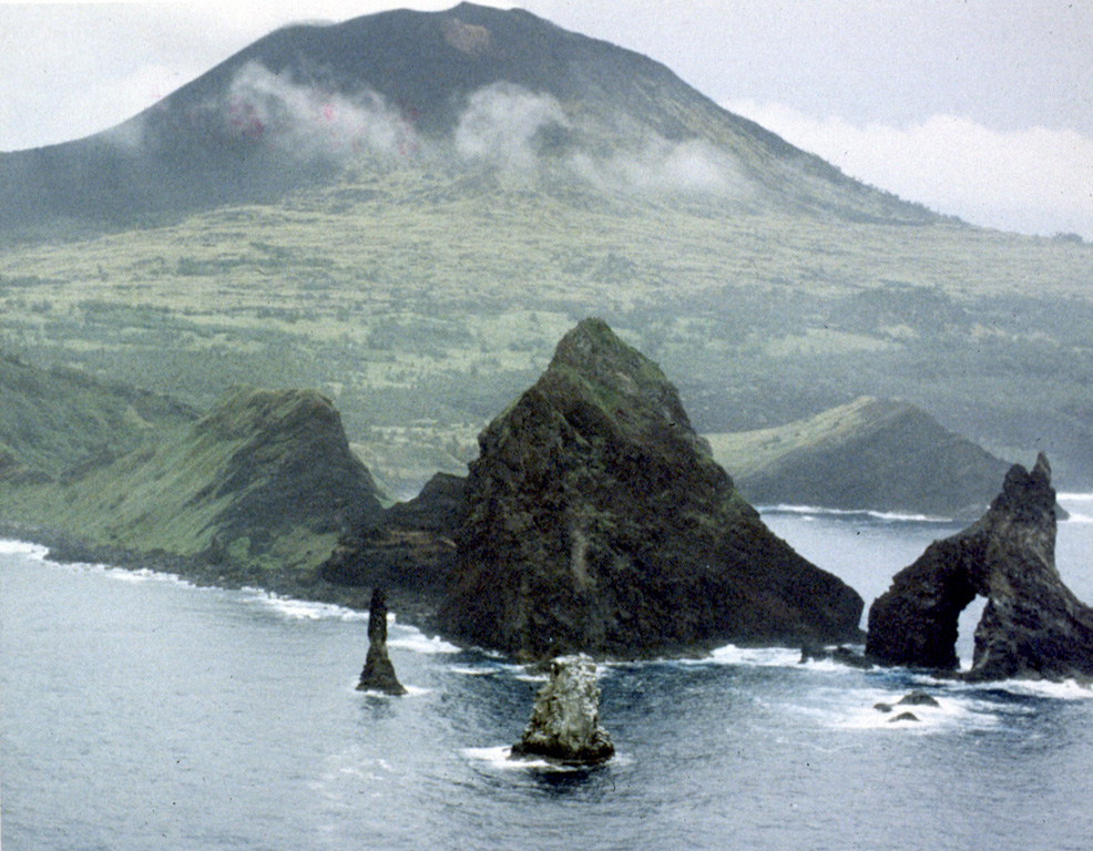 Pagan volcano rises above the Sengan Peninsula on its SSE flank. The peninsula in the foreground is eroded remnants of an older edifice that had a 7-km-wide caldera. North Pagan, the most active of two volcanoes on Pagan Island, was constructed within the past 3,000 years. Photo by U.S. Navy, 1982.