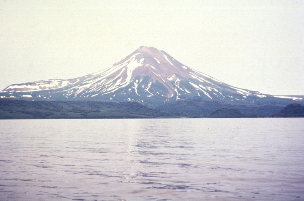 Iliinsky volcano, seen here across Kurile Lake from the SW at the outlet of the Ozernaya River, was constructed during the past 7,600 years above the NE rim of Kurile Lake caldera. The flat ridge with a steep terminus on the left horizon consists of north-flank lava flows that were emplaced about 1,500-2,000 years ago. Photo by Oleg Dirksen, 1996 (courtesy of Vera Ponomareva, Institute of Volcanic Geology and Geochemistry, Petropavlovsk).