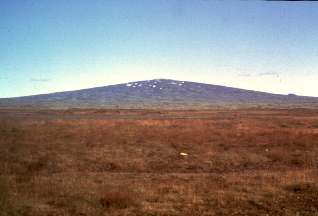 The classic Icelandic shield volcano Skjaldbreiður, seen here from the W along Route 52, formed about 9,500 years ago during a long eruption in the southern part of the Oddnyjarhnjukur-Langjokull volcanic system in central Iceland. It produced 17 km3 of basaltic lava flows and is capped by a small 300-m-wide summit crater. Photo by Richie Williams, 1981 (U.S. Geological Survey).