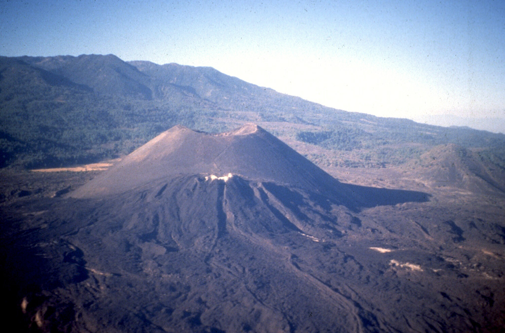 Parícutin, the volcano that grew in a cornfield in 1943, is a well-known feature of the Michoacán-Guanajuato volcanic field. The huge field contains over 1,400 vents covering a wide area across the Michoacán and Guanajuato states. Scoria cones are the predominant volcanic landform, and lava domes, maars, tuff rings, and lava flows are also present. Parícutin is seen here from the NE with the Nueva Juatita flank vent in the foreground, the main source of lava during the last five years of the eruption. Photo by Jim Luhr, 1997 (Smithsonian Institution).