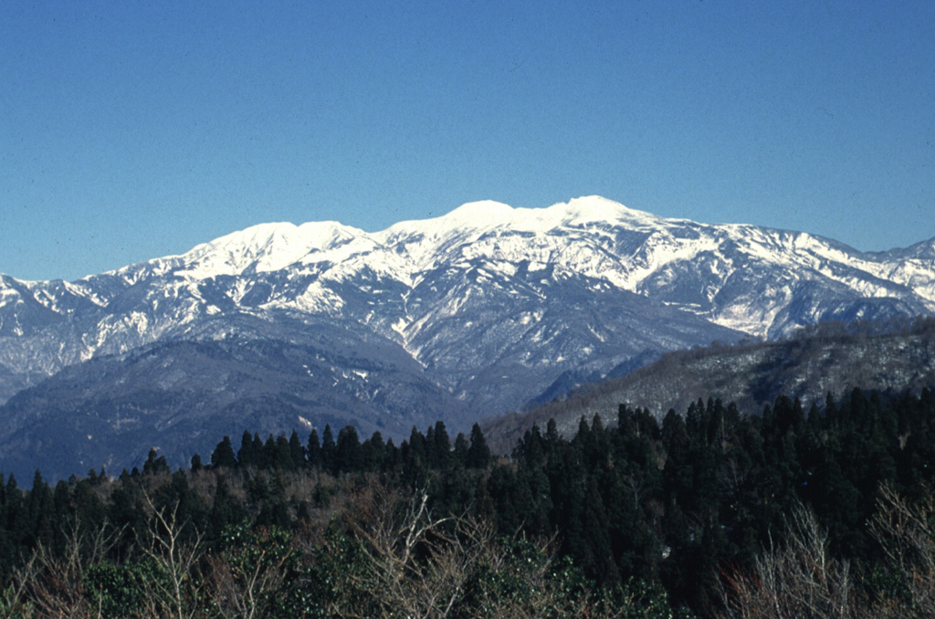 Hakusan, seen here from the WNW, contains multiple vents along a roughly N-S line. Holocene eruptions have consisted of phreatic or phreatomagmatic explosions from several summit craters. Partial collapse of the summit produced a debris avalanche down the E flank. Eruptions were recorded over almost a thousand-year period until the 17th century. Photo by Ishikawa Prefecture, 1994 (courtesy Toshio Higashino, Haku-san Nature Conservation Center).