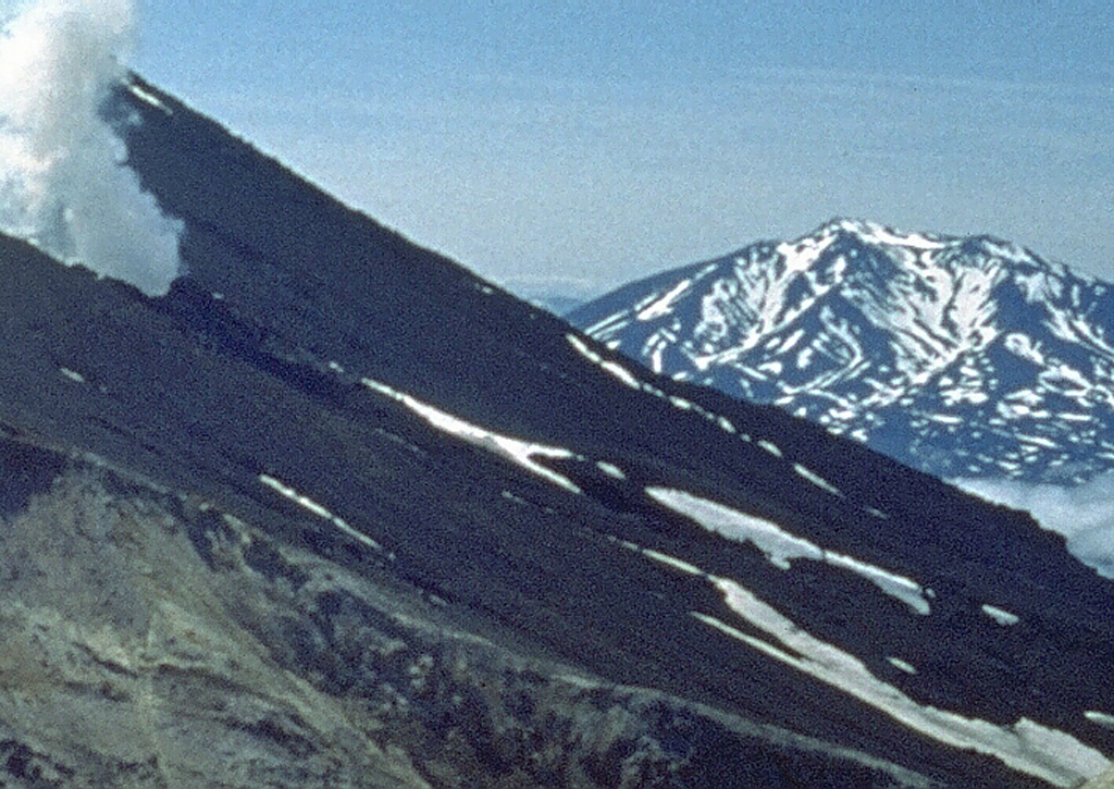 The Asacha volcano group is seen here looking WSW from the slopes of Mutnovsky. Most of the complex was constructed during the Pleistocene, but some of a group of ten lava domes across the flanks of the complex may be early Holocene in age. During the Holocene, scoria cones and lava flows also erupted along the western and southern flanks of the Asacha complex. Photo by Oleg Volynets (Institute of Volcanology, Petropavlovsk).