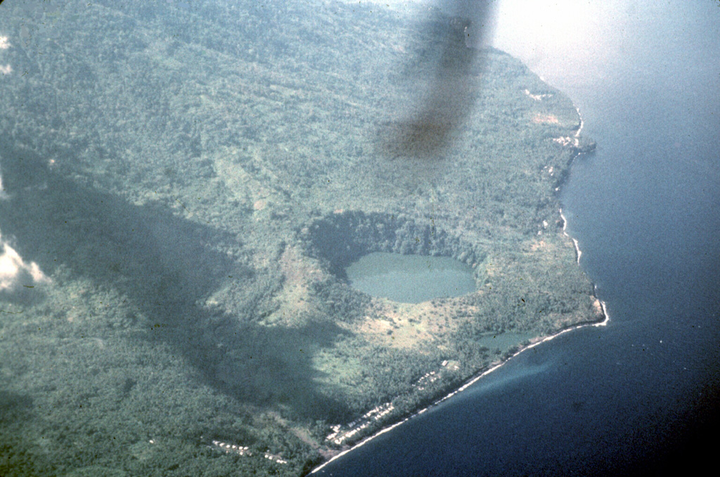 An aerial view from the north shows the steep-walled Tolire Jaha maar and the smaller Tolire Kecil maar, the small lake immediately adjacent to the shoreline.  The two maars were formed during a violent eruption in 1775.  The eruption began with explosive activity at the summit on August 20.  On the night of September 5-6 a devastating base surge accompanying formation of the 700-m-wide maar was responsible for most of the 141 people that were killed during the eruption.  The eruption ended with renewed NW-flank explosions November 5-6. Photo by Jack Lockwood, 1980 (U.S. Geological Survey).