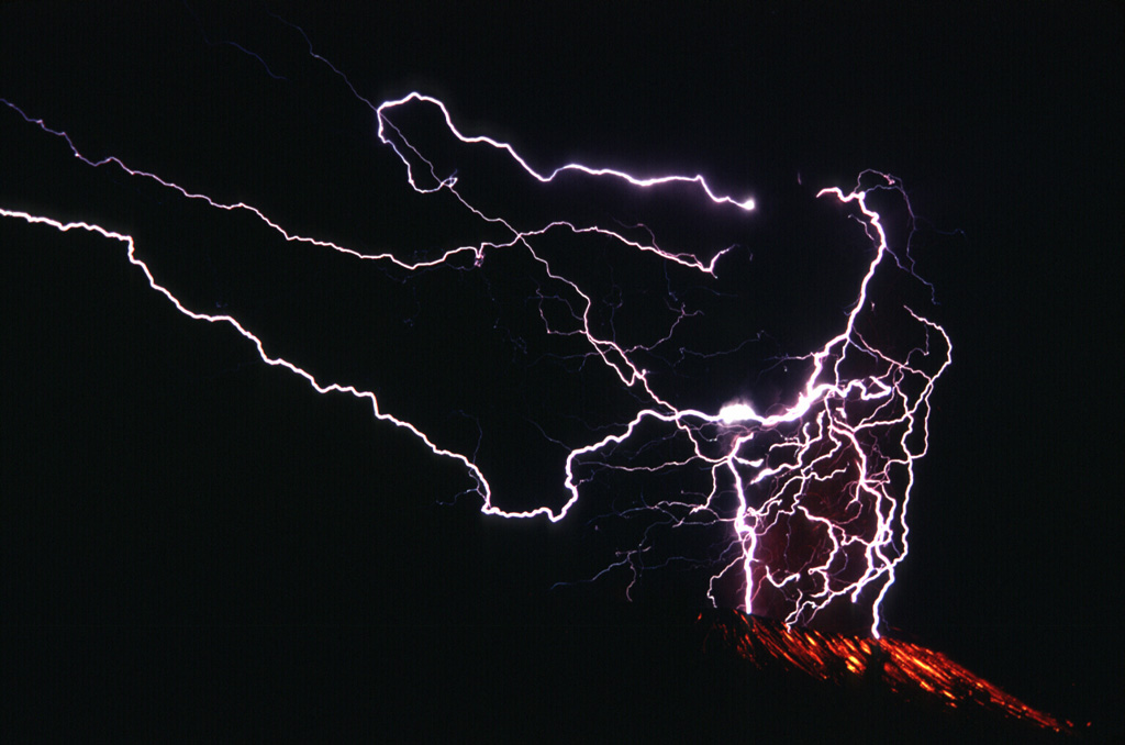 Lightning flashes in the Galunggung ash plume in this long exposure photo from 16 September 1982. This 2.5-minute-long time exposure shows the lightning strokes in the eruption column and incandescent bombs on the outer flanks below the crater. Photo by Jack Lockwood, 1982 (U.S. Geological Survey).