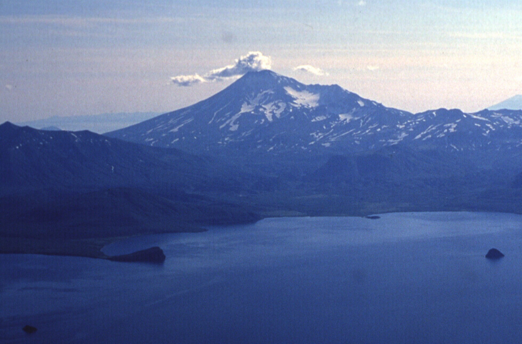 Kambalny is the southernmost large volcano on the Kamchatka peninsula, seen here above the SW shores of Kurile Lake caldera. There are scoria cones and lava flows on the W and SE flanks that suggest the possibility of very recent eruptions. Active fumarolic areas are found on the flanks. Photo by Nikolai Smelov, 1996 (courtesy of Vera Ponomareva, Inst. Volcanic Geology & Geochemistry, Petropavlovsk).