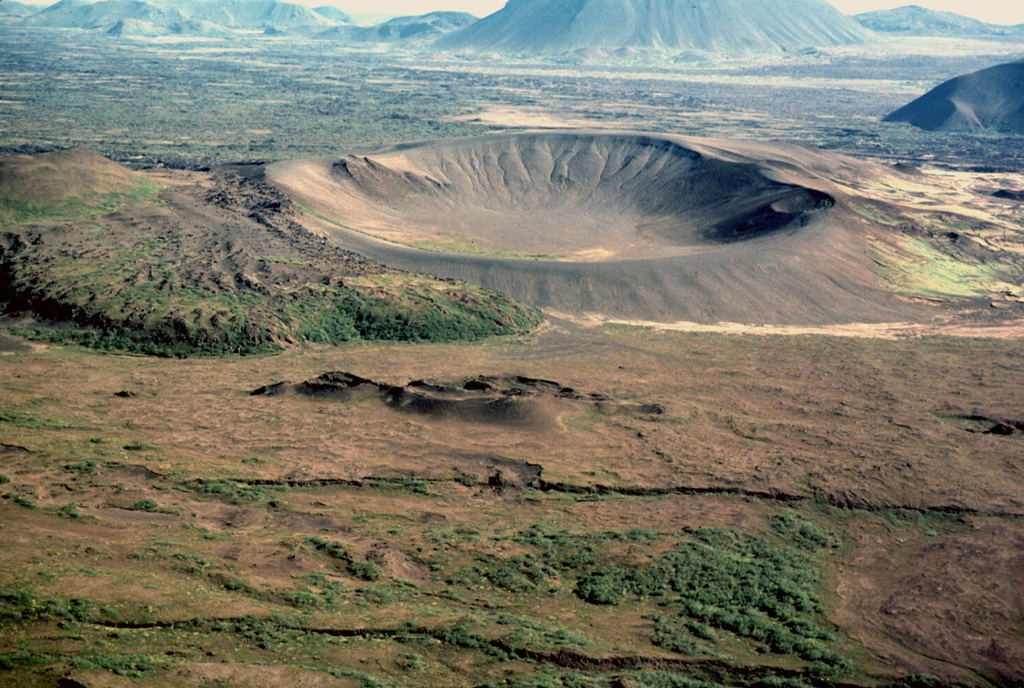 The Ludent tuff ring, seen here from the west, formed in a phreatomagmatic eruption in the early Holocene. The Ludentsborgir crater row in the foreground formed during an eruption about 2,200 years ago which produced the massive lava flows that entered Mývatn lake and traveled about 60 km, reaching the northern coast of Iceland. Photo by Michael Ryan, 1984 (U.S. Geological Survey).