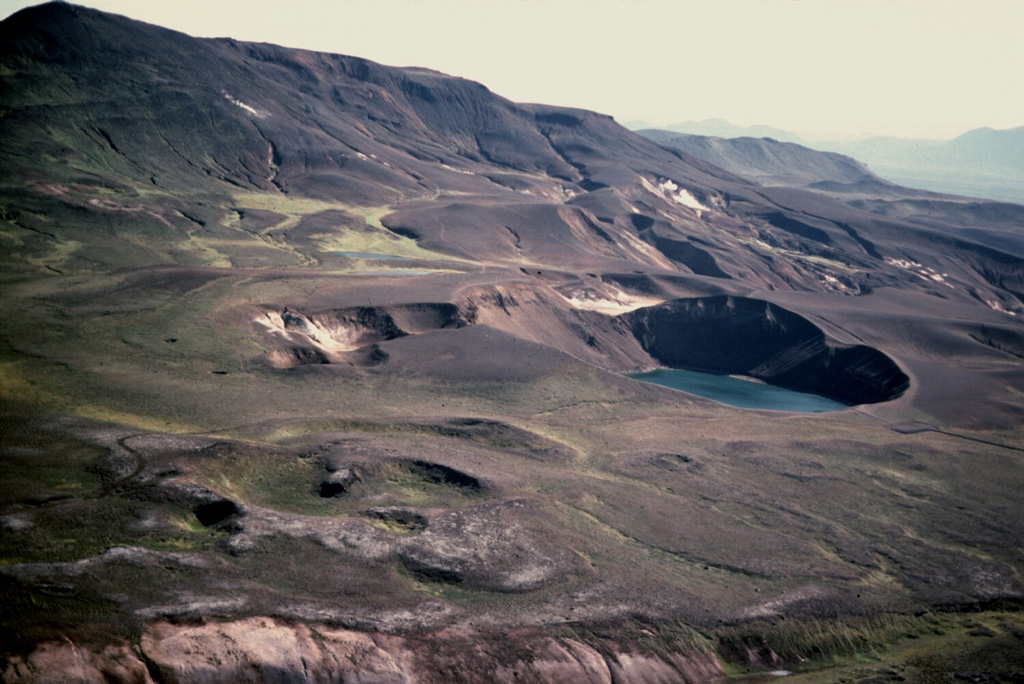 The 350-m-diameter Viti Crater (right center) and 14 other smaller craters were formed during 1724 at the start of a five-year period of rifting and eruptions known as the "Myvatn Fires." Krafla mountain, located east of Viti (upper left), is composed of hyaloclastic rocks formed during subglacial eruptions. It is one of the most prominent features in the Krafla caldera. The 1724 eruption forming Viti maar produced tephra fall over 12 km. Photo by Michael Ryan, 1984 (U.S. Geological Survey).