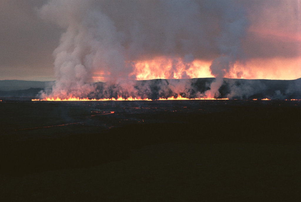 Lava fountains erupting along a fissure at Iceland's Krafla volcano early in the morning on 5 September 1984. A gas plume is visible along the length of the fissure. During the first hours of the eruption, which began just before midnight on the 4th, two eruptive fissures joined to become active along a total length of 8.5 km. Photo by Michael Ryan, 1984 (U.S. Geological Survey).