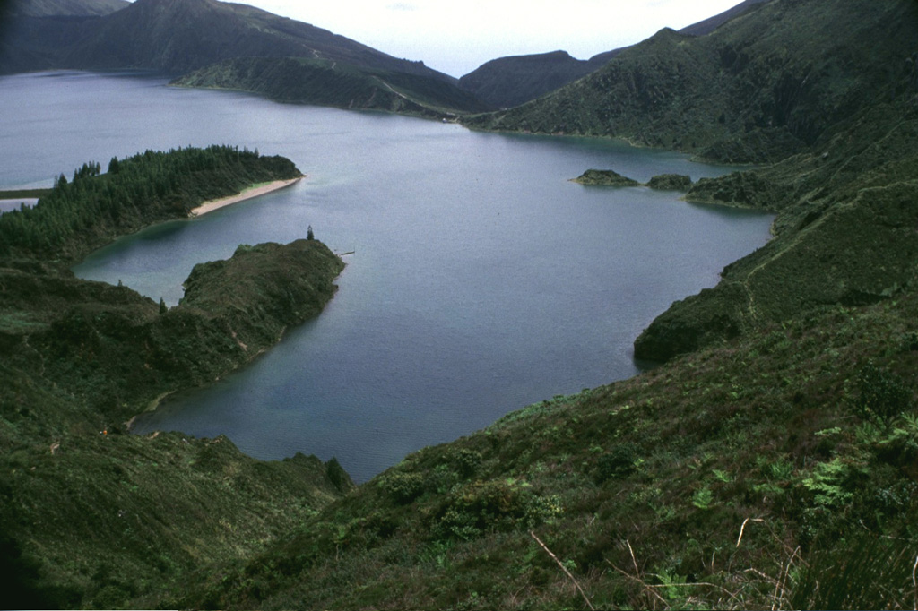 Lagoa do Fogo ("Fire Lake") is seen here from the northwest caldera rim of Agua de Pau. A Plinian eruption from the central caldera began on 28 June 1563, depositing trachytic pumice predominantly eastward over the island. On 2 July an eruption began on the northwest flank, producing a lava flow that reached the northern coast at Ribeira Grande. Photo by Rick Wunderman, 1997 (Smithsonian Institution).