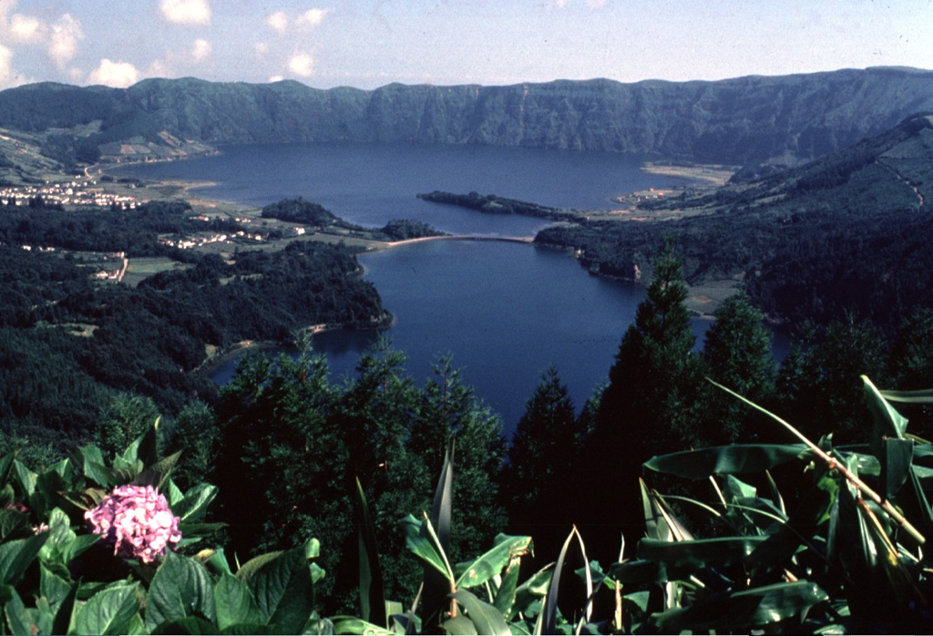 The summit caldera of Sete Cidades volcano at the western end of Sao Miguel Island contains two lakes and is one of the scenic highlights of the Azores.  A nearly circular ring of six Holocene pyroclastic cones occupies the floor of the 5-km-wide caldera and has been the source of a dozen major explosive eruptions during the past 5000 years.  Sete Cidades is one of the most active Azorean volcanoes.  Historical eruptions date back to the 15th century and have occurred from within the caldera and from submarine vents off the west coast.   Copyrighted photo by Katia and Maurice Krafft, 1980.