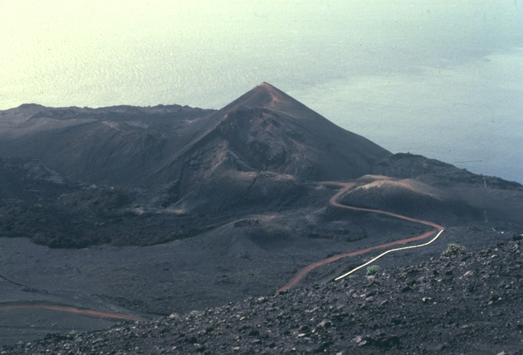 The dorsal spine of La Palma island is sprinkled with cinder cones, craters, and fissure vents formed during historical eruptions dating back to the 16th century.  Many of these produced lava flows that reached the sea.  The entire southern tip of the island was covered by lava flows during eruptions from the San Antonio (Fuencaliente) vent in 1678 and Teneguía cinder cone in 1971. Copyrighted photo by Katia and Maurice Krafft, 1977.