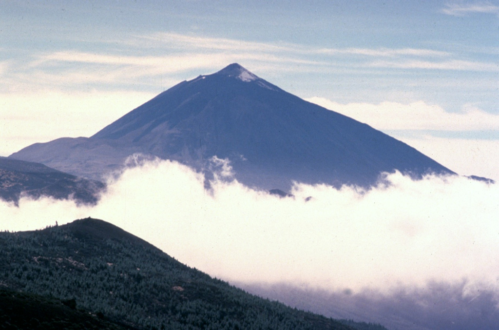 The 3715-m-high Teide stratovolcano, the highest peak in the Atlantic Ocean, dominates the island of Tenerife.  Pico de Teide was constructed within the 10 x 17 km Las Cañadas caldera.  The NE-trending Cordillera Dorsal volcanic massif joins the Las Cañadas volcano on the SW side of Tenerife with older volcanoes, creating the largest of the Canary Islands.  Tenerife was observed in eruption by Christopher Columbus, and several other flank vents on the most active volcano of the Canary Islands have erupted during historical time. Copyrighted photo by Katia and Maurice Krafft, 1977.