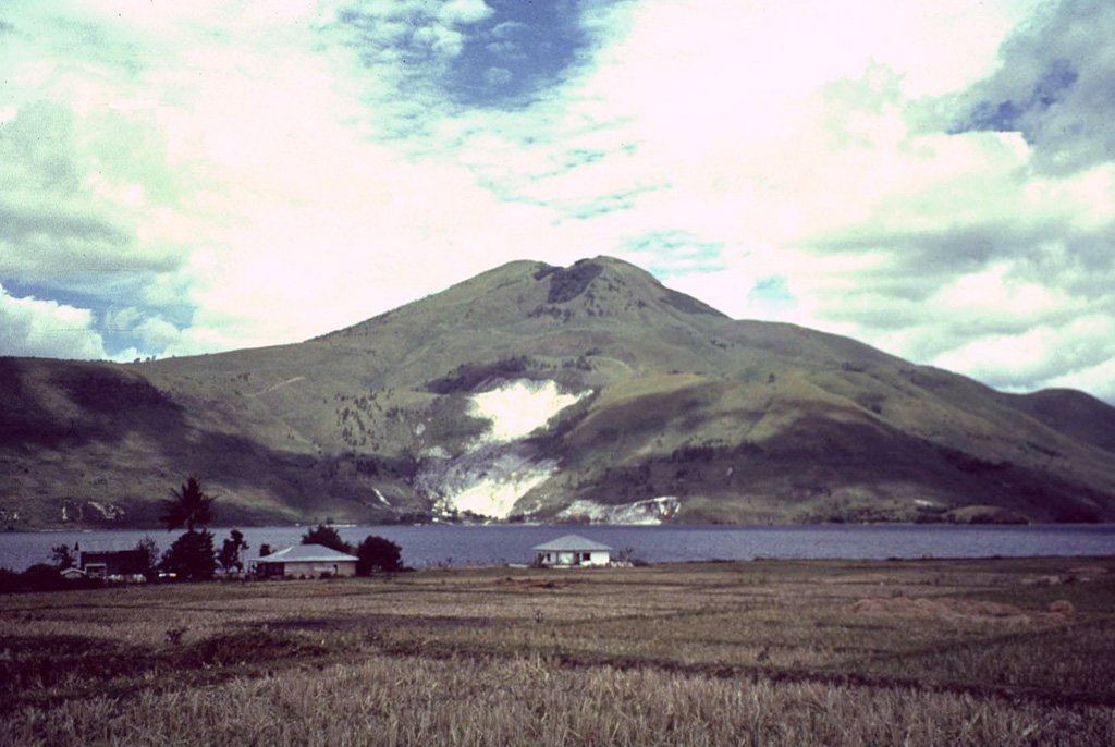 Pusukbukit, a volcano in the Toba caldera, was constructed just within the western caldera rim. It is seen here across a narrow strait from Samosir Island, with light-colored areas containing fumaroles along its northern flank. The youngest lava flow on Pusukbukit is of dacitic composition. Photo by Mike Dolan, 1993 (Michigan Technological University).