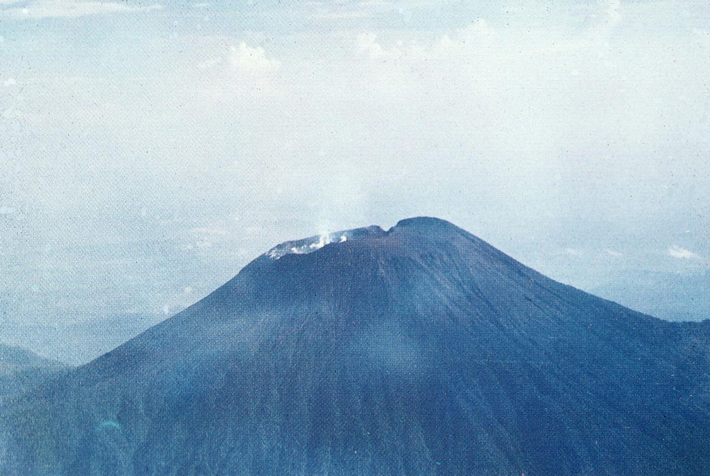The summit crater of Slamet, Java's second highest volcano at over 3.4 km elevation. Historical eruptions at Slamet have been recorded since the 18th century and have originated from a 150-m-deep, 450-m-wide, steep-walled crater (at the time of this photo). The eruptions have generally been explosive, lasting a few days to a few weeks. Photo by I. Pratomo, 1990 (Volcanological Survey of Indonesia).