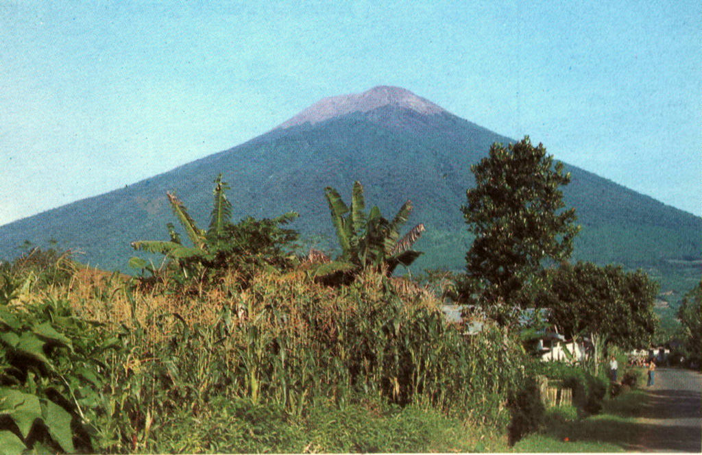 Gunung Slamet, Java's second highest volcano, towers above the village of Kutabawa. This is one of Java's most active volcanoes and has produced frequent explosive eruptions that have been recorded since the 18th century. Photo by Igan Supriatna, 1990 (Volcanological Survey of Indonesia).
