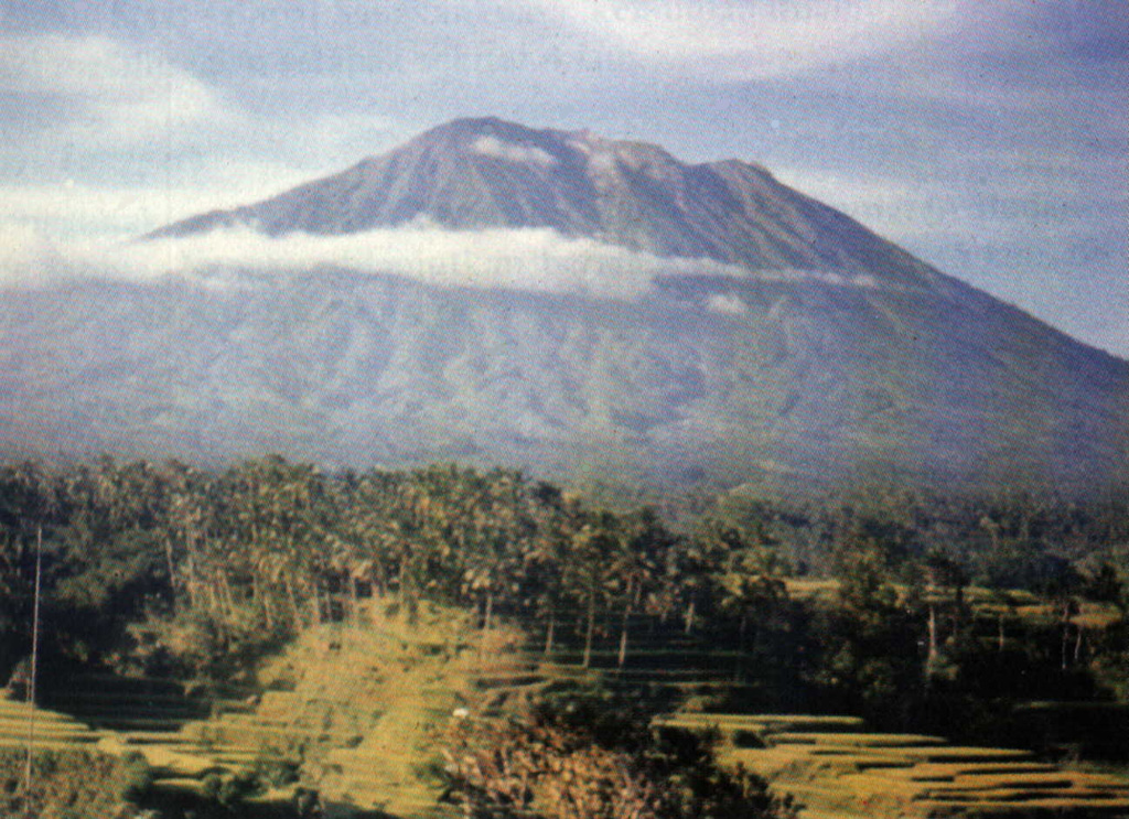 Gunung Agung towers above rice fields near the Rendang volcano observation post. The stratovolcano has erupted infrequently during historical time, but its 1963 eruption was one of the most devastating in Indonesia during the 20th century.  Photo by M.E. Ilyas, 1991 (Volcanological Survey of Indonesia).