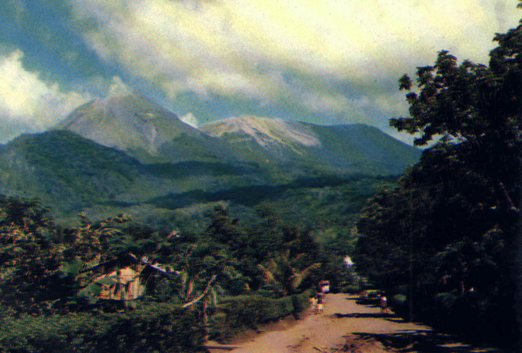 Lewotobi Lakilaki (left) and Lewotobi Perempuan (right) rise above a village on their western flanks. Both the conical Lakilaki and the broad Perempuan volcanoes have erupted during historical time. Photo courtesy of Volcanological Survey of Indonesia, 1990.