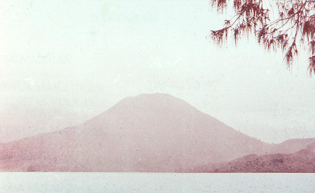Iliboleng volcano rises above the Boleng strait between Adonara and Lomblen Islands, at the eastern end of the Lesser Sunda (Nusa Tenggara) Islands.  The symmetrical volcano, which occupies the SE corner of Adonara, is seen here from the NE tip of the island.  The 1659-m-high stratovolcano, the only historically active volcano on the island, is one of the most active in the Lesser Sundas. Photo by O. Rukman, 1985 (Volcanological Survey of Indonesia).