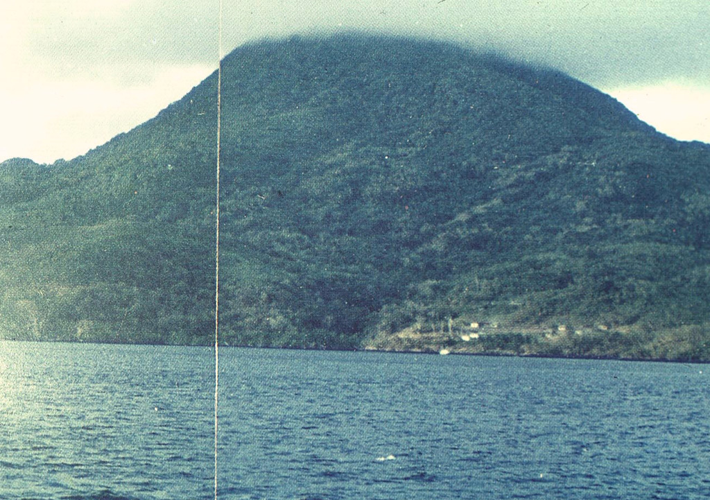 Nila Island, viewed here from off its northern coast, is the emergent summit of a stratovolcano that rises 3700 m from the Banda Sea floor.  A submarine vent is located off the north flank immediately west of the small island of Nika.  Gas bubbles were observed along the rim of the submarine cone in 1932, when an eruption occurred from a fissure extending from the summit to the SE coast.  Photo by Rizal, 1976 (Volcanological Survey of Indonesia).