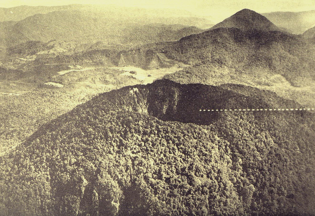 Forested Taman Saat crater, seen here in an aerial view from the south, is one of two summit craters at Gunung Patuha volcano. The steep-walled crater is about 350 m wide and 165 m deep.  Photo published in Taverne, 1926 