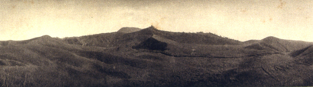 This view from the east shows the N-S-trending crater complex of Inielika volcano. At the far left is Wolo Lega crater, and the 1905 crater is located just right of center. The high point at the center of the photo is Wawolika cone. Photo published in Kemmerling 1929, 