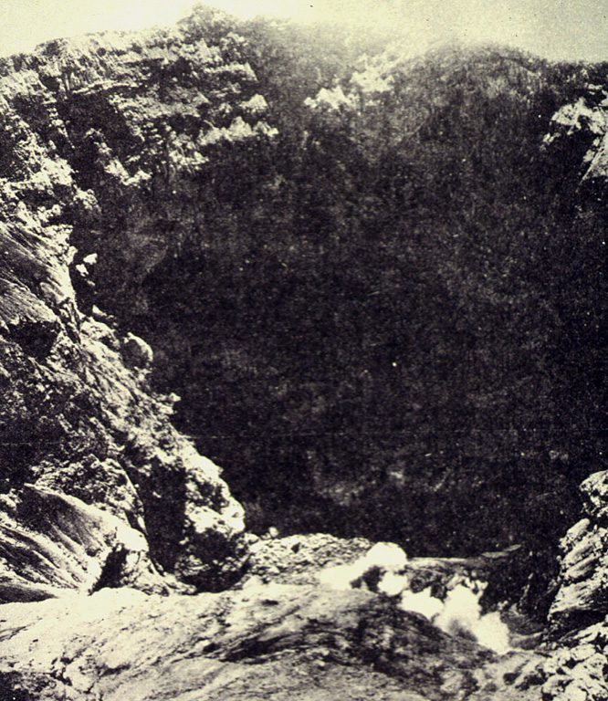 The steep-walled, 600-m-wide summit crater of Kerinci volcano seen from the southern rim. The crater, which is located at the summit of Indonesia's highest volcano, is 450 m deep and is often contains a small lake. Photo by S. Wikartadipura, 1972 (published in Kusumadinata, 1979, 