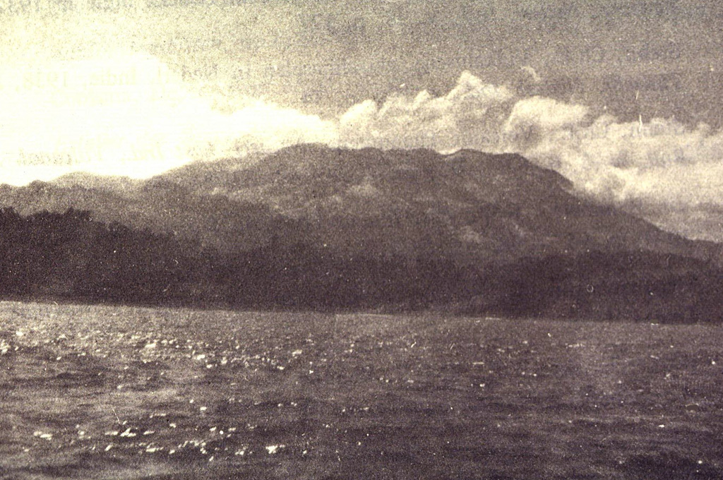 Massive Gunung Awu volcano is surrounded by the sea on three sides at the northern end of Great Sangihe Island.  The flat-topped summit is truncated by a large crater that has been the source of some of Indonesia's deadliest eruptions.  Deep valleys dissecting the volcano's flanks provide passageways for pyroclastic flows and lahars. Photo by J. Matahelumual, 1961 (Volcanological Survey of Indonesia).