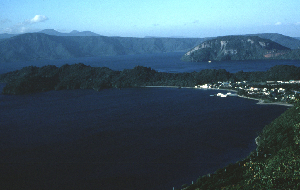 The 11-km-wide lake-filled Towada caldera, whose far northern wall is seen here in the distance, formed during a series of major explosive eruptions over a 40,000-year period ending about 13,000 years ago. The peninsula across the center is the rim of Nakanoumi caldera that formed by the collapse of the Goshikiiwa cone. The Ogurayama dome to the upper right was the source of the 915 CE eruption. Photo by Yukio Hayakawa (Gunma University).
