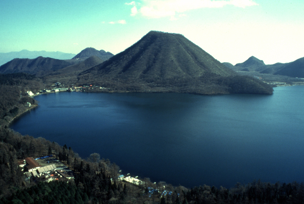 Haruna-Fuji is a cone of Harunasan, seen here above Lake Haruna in the W side of the caldera. The Futatsudake lava dome to the E was the source of two large explosive eruptions during the 6th century CE. Photo by Yukio Hayakawa, 1998 (Gunma University).