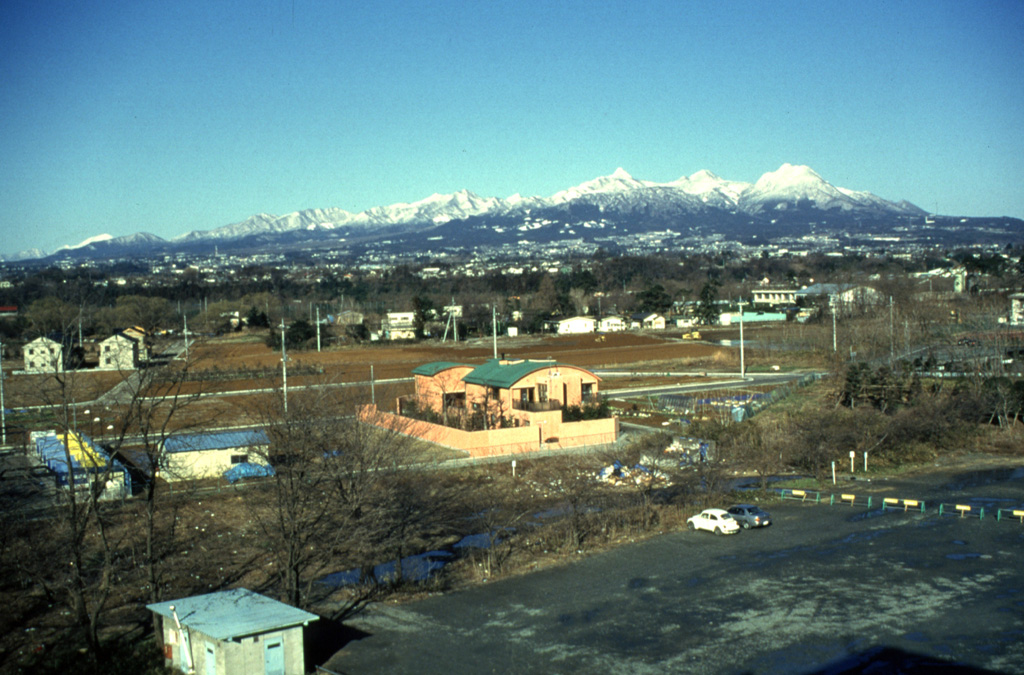 Harunasan volcano is seen here from Gunma University in the city of Maebashi to the SE. A small caldera is at the summit along with several cones and lava domes that have formed within it. Two major explosive eruptions originated from the Futatsudake lava dome on the eastern side of the volcano during the 6th century. Photo by Yukio Hayakawa, 1998 (Gunma University).